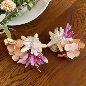 Detailed view of beach-style starfish and fabric flower duckbill hair clips with pearls