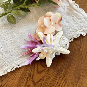 Close-up detail view of a beach-themed hair clip featuring starfish, shells, and pearls