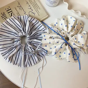 Top view of oversized striped and floral hair scrunchies with ribbons