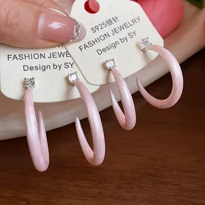 Vista detallada de pendientes de esmalte rosa en forma de C con circonitas y plata S925.