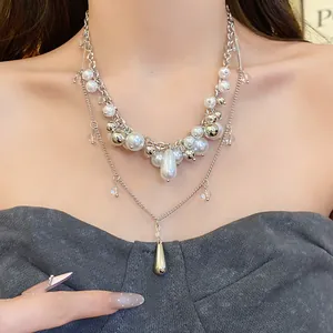 Close-up detail view of a multi-layer French style pearl necklace on a model's neck