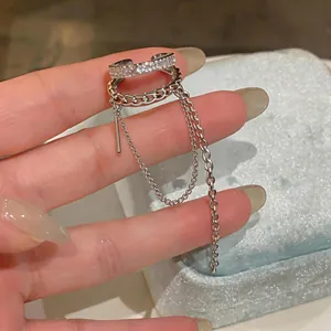 Close-up of silver-tone double-layer zircon ear cuff with dangling tassel chains