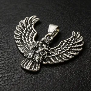 Detail view of a vintage blackened stainless steel eagle wing pendant on leather