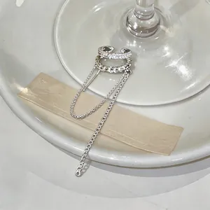 Detail view showing the sparkling zircon-studded double layer ear cuff with long tassel chain.