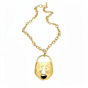 Gold chunky link chain necklace with an engraved vintage padlock pendant and keyhole