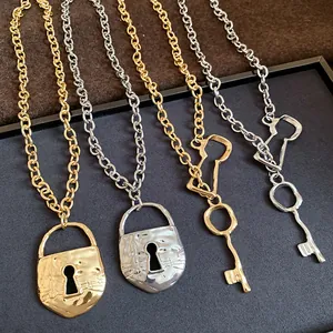 Detailed view of gold and silver retro chunky chain necklaces with lock and key pendants.