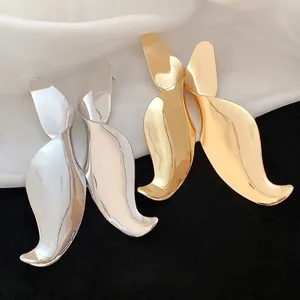 Elegant large twisted geometric pendant drop earrings in gold and silver finishes.