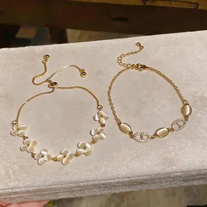 Elegant gold bracelets featuring clover shapes, cat's eye stones, and zircon accents.