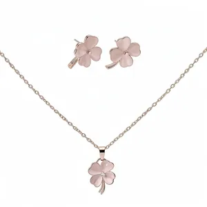 Rose gold four-leaf clover jewelry set with pink cat-eye stone necklace and earrings