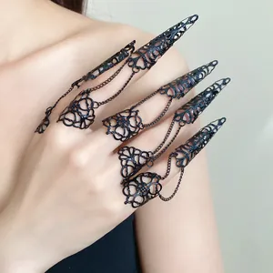 Detailed view of Gothic black filigree finger sleeve rings with connected chains