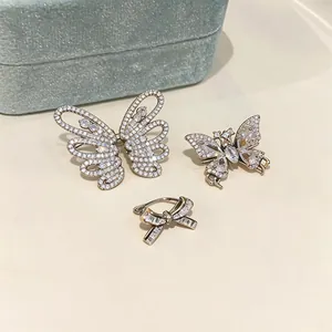 Detailansicht von funkelnden Schmetterlings- und Schleifen-Ohrklemmen mit Zirkonia.