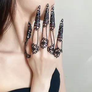 Detailed view of Gothic black hollow-out finger claw rings with delicate chains