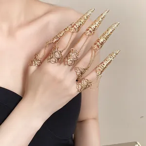 Detailed view of golden gothic hollow finger claw rings with delicate chains