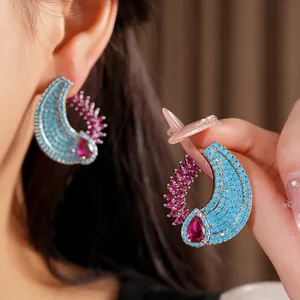 Vintage teardrop zircon earrings featuring turquoise stones and ruby accents on model
