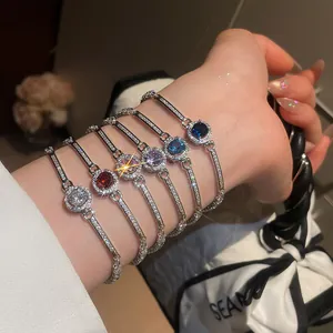 Close-up of elegant silver-toned bracelets with sparkling multi-colored round zircons