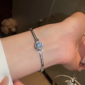 Detailed close-up view of a sparkling silver zircon bracelet on a wrist with elegant jewelry style