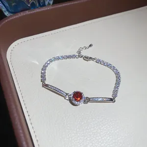 Macro view of vintage silver-tone bracelet with sparkling red stone and zircon pavé.