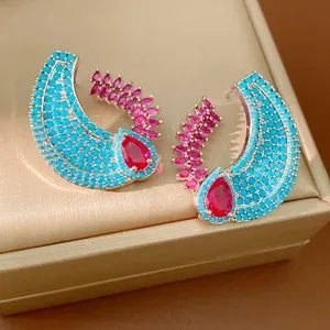 Detailed close-up of vintage teardrop earrings with turquoise pavé and ruby red zircons