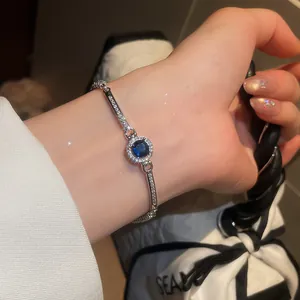 Elegant silver vintage bracelet with a sparkling round blue zircon, worn on wrist