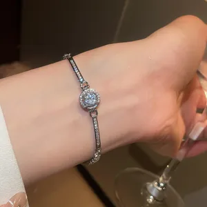 Close-up of a high-end sparkling round zircon bracelet worn on a woman's wrist.