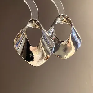 Elegant geometric hollow earrings with a minimalist silver metallic finish for women