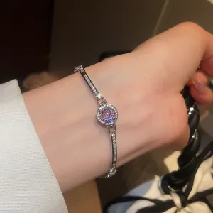 Close-up shot of an elegant vintage circular pink zircon bracelet worn on a woman's wrist