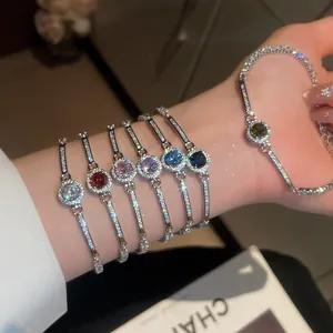 Close-up detail of vintage round zircon bracelets in multiple colors worn on wrist