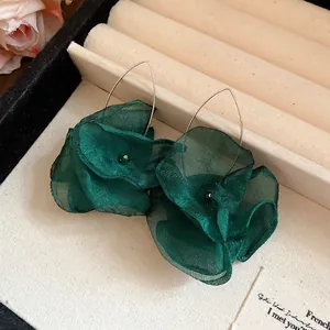 Detailed macro view showing the delicate emerald green chiffon flower petals of these drop earrings