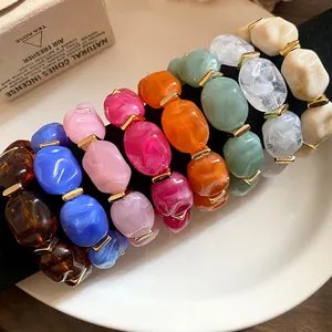 Close-up of colorful acrylic chunky bracelets with irregular geometric oval beads