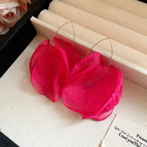 Close-up view showing the delicate texture of fuchsia chiffon flower drop earrings.