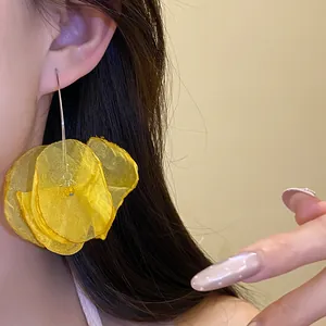 Detail view of vibrant yellow chiffon flower drop earrings with elegant chiffon petals.