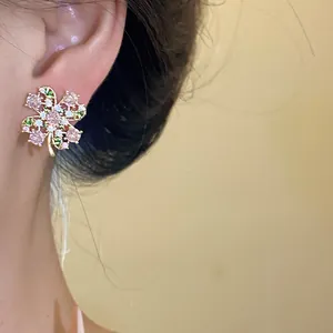 Detail view of vintage zircon butterfly stud earrings worn on an Asian model's ear.