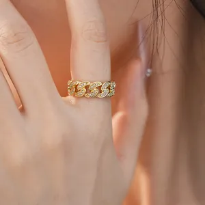 Macro close-up detail of 14k gold plated cubic zirconia Cuban link chain open ring