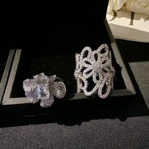 Close-up detail of two exquisite hollow floral rings with sparkling zircons in a jewelry box