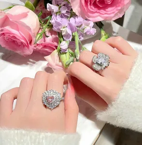 Detailed close-up view of elegant zircon-encrusted flower and heart-shaped open rings