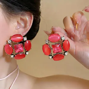 Vintage exaggerated pink cat's eye stud earrings with sparkling crystal floral design