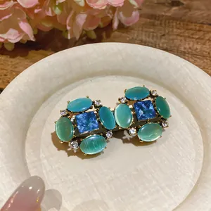 Vintage cat's eye stone earrings with blue crystals and silver needle design for women