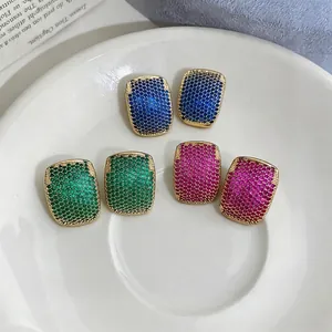 Elegant French style geometric zircon stud earrings in various colors set on a white plate