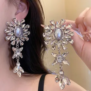 Luxury floral rhinestone earrings with white pearls in a multi-layer star design