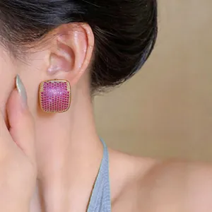 Close-up of elegant square stud earrings with pink zircon pavé detailing
