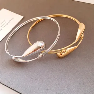 Elegant double-layer metal open bangle with water drop charm in gold and silver