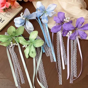 Elegant handmade lace and fabric flower hair clips with long ribbons in soft pastel colors