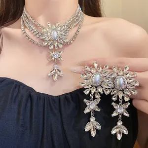Detail showing the intricate rhinestone flower design and layered pearl necklace set.