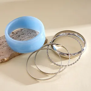 Close-up detail of 5-piece set featuring light blue resin and silver metal bangles