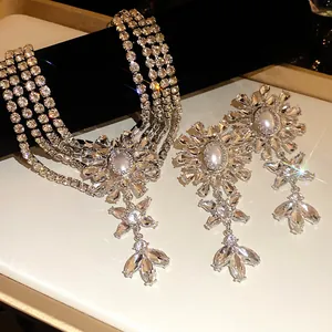 Macro detail of luxury sparkling crystal floral necklace and drop earrings jewelry set