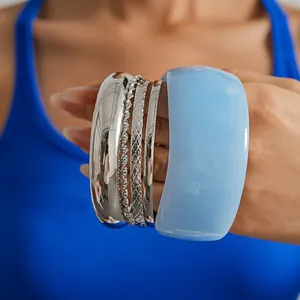 Close-up detail of a five-piece set featuring metallic silver and blue resin geometric bangles
