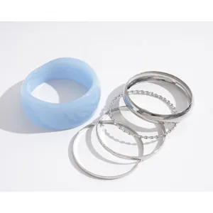 Minimalist 5-piece bracelet set with light blue resin bangle and silver metal rings