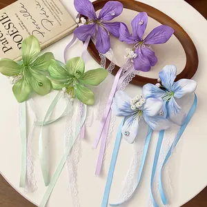 Elegant lace flower hair clips with colorful ribbons and delicate fabric petals