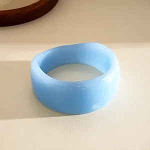 Detailed macro view of a light blue chunky resin geometric bangle with a smooth finish.