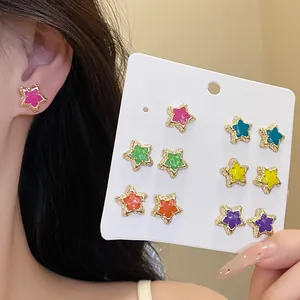 Vibrant Mori style set of 12 colorful enamel star stud earrings shown with wearing effect